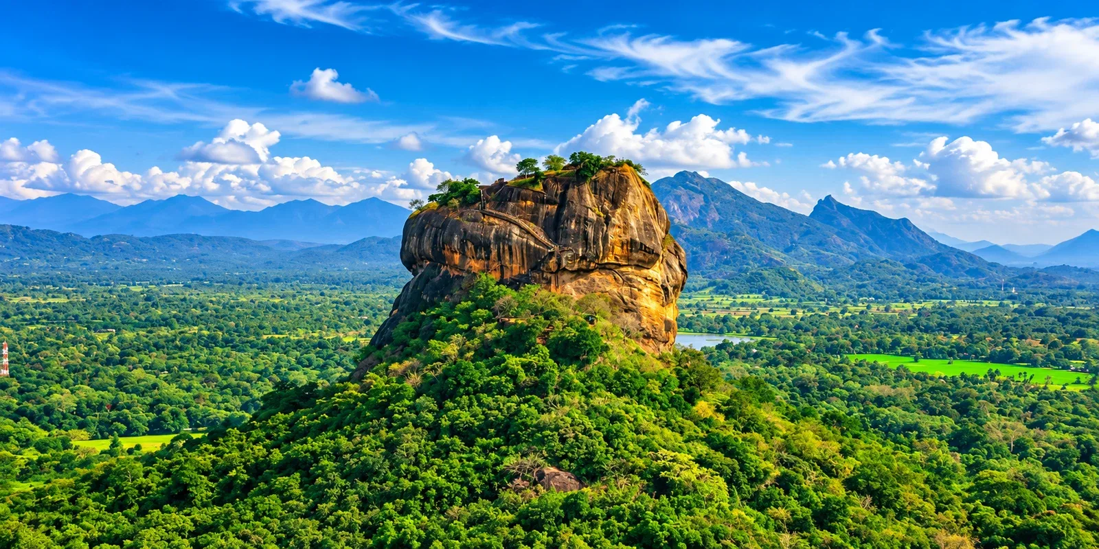 Sigiriya rock rising above green countryside
